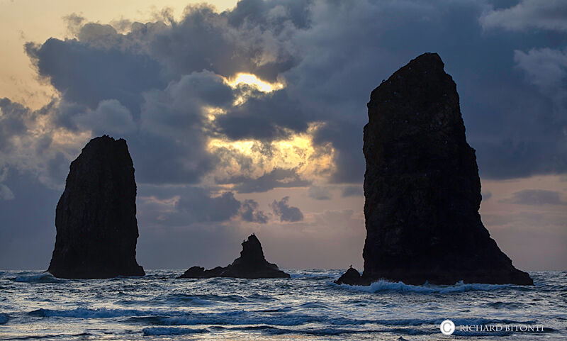 Two iconic sea stacks silloueted on the shoreline at Cannon Beach, Oregon. These two stacks are just south of the large stack...