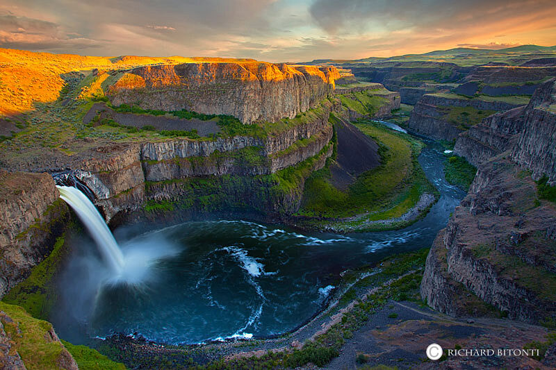 The late afternoon sunset casts a warm glow on the rim of Palouse Falls, located in southeast Washington.&nbsp;